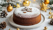 © Steve - a mouth-watering, richly textured chocolate gingerbread cake with its perfectly baked texture and dusted sugar on top, centered in the frame. The cake is presented beautifully on a white plate set aga