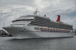 © Tamme - Modern main line cruiseship cruise ship liner Victory sail away departure from Miami port, Florida for summer Caribbean cruising with city buildings in background and passengers on deck celebrating