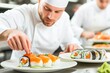 © Babycrab - A chef meticulously plates sushi in a restaurant kitchen, showcasing culinary skill and artistry.