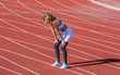 © Yevhen - Tired girl on stadium. Sports, race and an athlete runner, fitness, running or exercise on track. Break, tired woman at stadium for a workout, training or breathing after cardio
