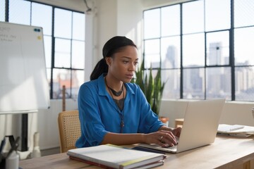 Aufkleber - Focused businesswoman working on laptop in modern office
