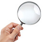 © Dan - a hand holding a magnifying glass