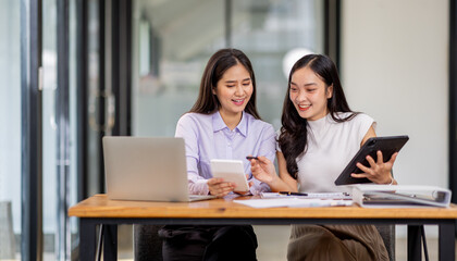 Wall Mural - Financial Business two women analyze the graph of the company's performance to create profits and growth, Market research reports and income statistics, Financial and Accounting concept.	