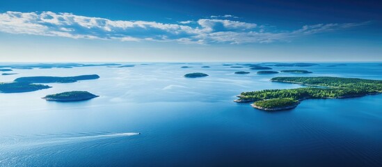 Poster - Tranquil blue sea with island silhouettes under a clear sky showcasing the serenity of coastal landscapes and natural beauty.