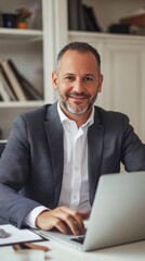 Aufkleber - A man in a suit is sitting at a desk with a laptop in front of him