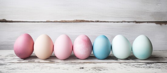 Aufkleber - Pastel colored Easter eggs arranged on a rustic wooden table for a spring holiday celebration concept.