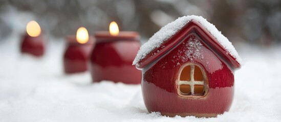 Poster - Festive red ceramic candle house adorned with a snowy rooftop perfect for Christmas decorations against a soft white backdrop