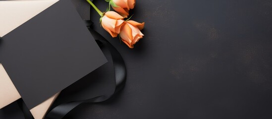 Poster - Elegant greeting card mockup with black frame and ribboned gift box surrounded by roses on dark background for creative designs.