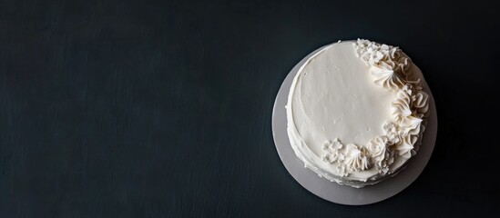 Aufkleber - Elegant white wedding cake with floral decoration on a dark background showcasing minimalist design and aerial perspective