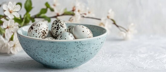 Aufkleber - Quail eggs in a light blue bowl surrounded by spring flowers on a textured white backdrop showcasing minimalist design and seasonal freshness