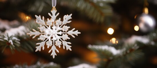 Poster - Christmas tree ornament showcasing a large white snowflake surrounded by festive decorations and warm holiday lights.