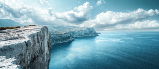 Poster - Stunning cliffs against tranquil blue sea under a clear sky with clouds showcasing nature's beauty and serenity in a coastal landscape.