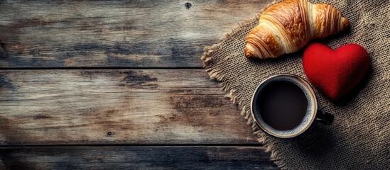 Poster - Croissant coffee and a red heart on a rustic wooden surface creating a warm inviting breakfast or snack scene with selective focus.