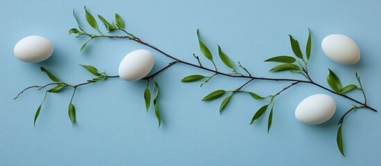Aufkleber - Fresh eggshells and willow branches with green leaves arranged artistically on a soft blue background with ample copy space for design use