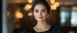© ArtificialHorizons - Elegant portrait of a confident woman with soft features and natural beauty in a stylish indoor setting with warm lighting.