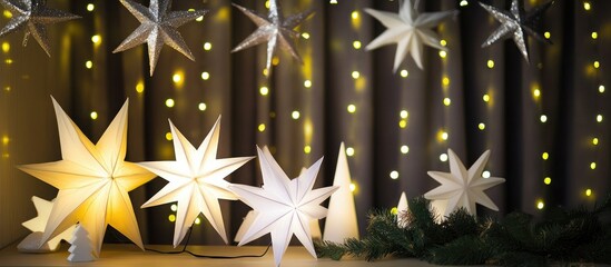 Poster - Christmas star ornaments illuminated by festive lights creating a warm holiday ambiance and seasonal spirit indoors
