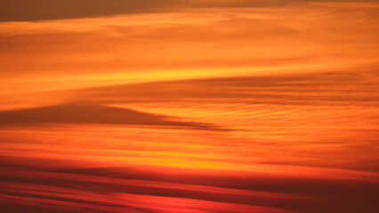 Wall Mural - Abstract orange and red sunset sky with layered clouds. Nature background for design and print