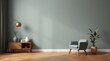 © NipaArts - A light blue armchair in a living room with a large green wall, wooden floor, a side table, and a potted plant.