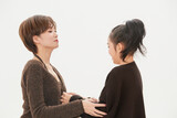 Beautiful mother and cute daughter portrait on white background