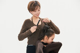 Beautiful mother and cute daughter portrait on white background