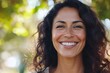 © Anjali - Happy  confident middle aged Hispanic woman outdoors on sunny day.