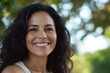 © Anjali - Happy  confident middle aged Hispanic woman outdoors on sunny day.