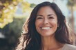 © Anjali - Happy  confident middle aged Hispanic woman outdoors on sunny day.