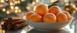 © CreativeBro - Tangerines in a bowl with cinnamon sticks and a beautiful bokeh background creating a warm and inviting holiday atmosphere