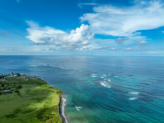 Aerial view of beautiful Dieppe beach bay with a black sand beach, palm trees, and a reef that protects swimmers and snorkelers om St Kitts where the Caribbean sea and the Atlantic Ocean meet 