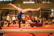 © samards - Young gymnast girl performing routine on balance beam