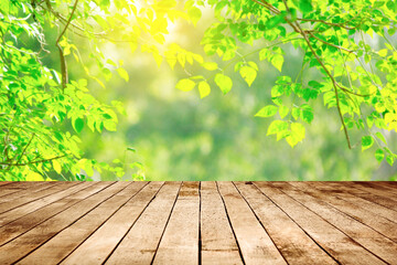 Canvas Print - empty wooden table on green leaves background