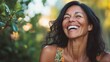 © WS Studio 1985 - Joyful Mature Woman Laughing Amidst Lush Greenery in Sunlight