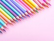© Елена Григорова - Row of sharpened colorful pencils aligned diagonally on a pastel pink background.
