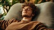© MaxStock - Relaxed young man resting on couch