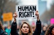 © Pete - Woman holds Human Right placard at protest. Female activist at demonstration. March for abortion rights. Social justice rally. Feminist fight for choice