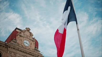 Wall Mural - French flag waving in front of the Mairie de Cannes Town hall in Cannes, France