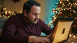 © Polonio Video - Young Man Looking For Gifts On Laptop Dissatisfied On Christmas Night In Room