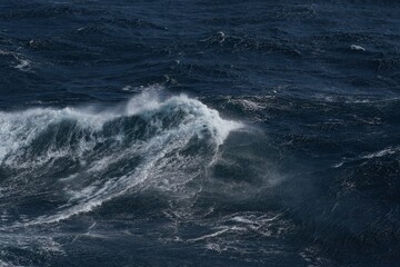 Wall Mural - powerful ocean waves crashing in dark sea, creating dramatic scene. turbulent water showcases nature