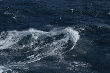 Wall Mural - dynamic ocean waves crashing against each other, creating dramatic seascape. deep blue water contras