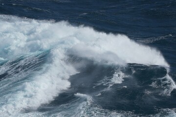 Wall Mural - powerful ocean waves crashing against each other, creating dramatic seascape. deep blue water contra