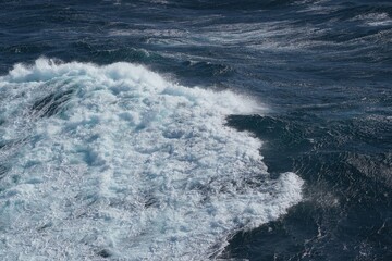 Wall Mural - dynamic ocean waves crashing against shore, creating foam and ripples, showcasing beauty of nature p