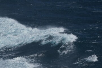 Wall Mural - waves crashing on dark ocean surface, creating dynamic and powerful scene. contrast of white foam ag