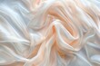 © Iftikhar alam - A close-up image of soft, flowing peach-colored silk fabric. The fabric is draped in gentle folds, creating a sense of elegance and luxury A close-up of soft, flowing silk fabric