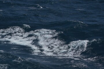 Wall Mural - rough ocean waves create dynamic and powerful seascape, showcasing beauty of nature force. deep blue