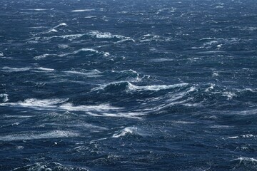 Wall Mural - vast ocean with turbulent waves creating dynamic seascape, showcasing power of nature. deep blue wat