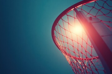 Aufkleber - A close-up view of a basketball hoop against a bright background.