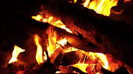Poster - Warm light illuminates the dark surroundings as logs burn and crackle, creating a cozy atmosphere for a nighttime gathering.