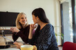 © Marko Geber - Two women discussing ideas at a office workplace