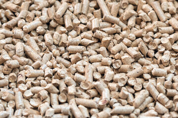 Wall Mural - Wood pellets closeup for cat litter, background texture