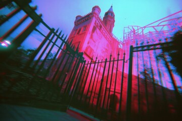 Poster - A surreal view of a castle-like structure through a distorted lens, evoking mystery.